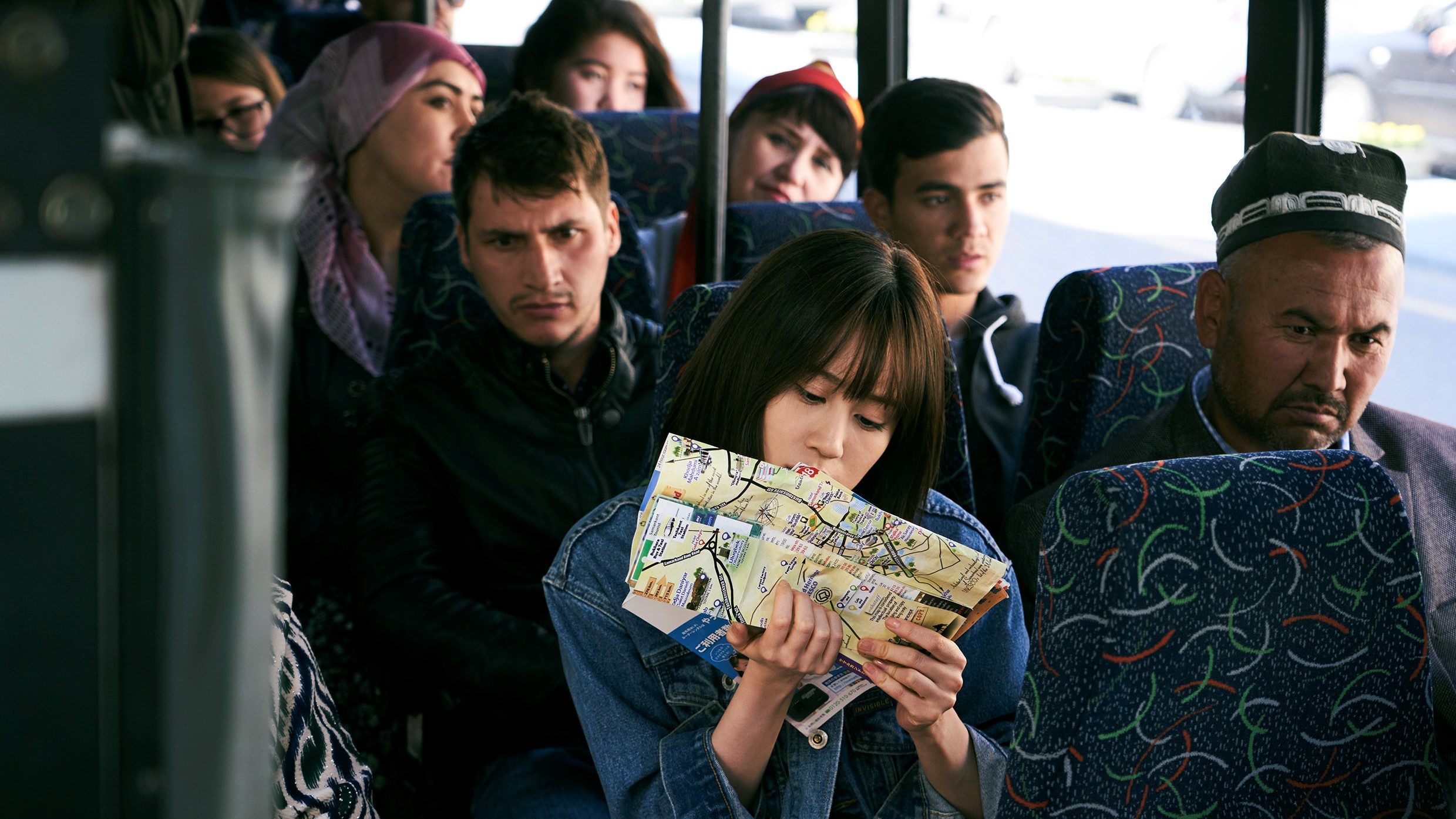 A group of people sitting at a bus stop